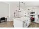 Modern kitchen featuring white cabinets, stainless steel appliances, and an island with bar seating at 157 Julliard Blvd, Davenport, FL 33897