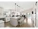 Bright, open kitchen featuring white cabinets, stainless steel appliances, and a large center island with bar seating at 157 Julliard Blvd, Davenport, FL 33897