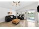 Bright living room featuring comfortable sofas and a view of the outside pool at 157 Julliard Blvd, Davenport, FL 33897