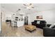 Open-concept living space showcasing the modern kitchen, comfortable seating, and bright, airy atmosphere at 157 Julliard Blvd, Davenport, FL 33897