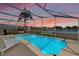 Enjoy this screened-in pool with a great view of the water and landscape at 157 Julliard Blvd, Davenport, FL 33897