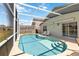 Relaxing screened-in pool with lounge chairs and access to the home through sliding glass doors at 157 Julliard Blvd, Davenport, FL 33897