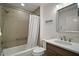 Clean bathroom featuring a shower/tub combo with modern fixtures and a wooden vanity with sink at 1627 Mclucas Ln, The Villages, FL 34762