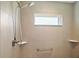 Modern tiled shower with adjustable shower head, safety bar, and built-in corner shelves at 1627 Mclucas Ln, The Villages, FL 34762