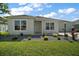 Well-maintained home with lush lawn and colorful landscaping at 1627 Mclucas Ln, The Villages, FL 34762