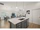 Open-concept kitchen featuring modern stainless-steel appliances and flowing into the living spaces at 1627 Mclucas Ln, The Villages, FL 34762