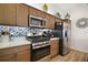 Kitchen area showcases modern appliances, tiled backsplash, updated cabinets and a stainless steel refrigerator at 1627 Mclucas Ln, The Villages, FL 34762