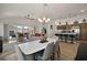 Open concept living and dining area with an adjacent kitchen offers ample natural light and wood-look floors at 1627 Mclucas Ln, The Villages, FL 34762