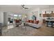 Open concept living area features a ceiling fan and comfortable seating, with views of the patio at 1627 Mclucas Ln, The Villages, FL 34762