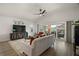 Open concept living room with vaulted ceiling, ceiling fan and sliding door access to the patio at 1627 Mclucas Ln, The Villages, FL 34762