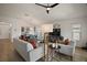 Bright living room features a ceiling fan, comfortable seating, and a view of the dining area at 1627 Mclucas Ln, The Villages, FL 34762