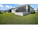 Home featuring a screened lanai and large backyard at 1627 Mclucas Ln, The Villages, FL 34762