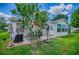 Home's backyard featuring well-maintained lawn, patio, and outdoor dining area at 17009 Se 96Th Chapelwood Cir, The Villages, FL 32162