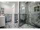 Contemporary bathroom featuring glass enclosed shower with built-in niche and modern fixtures at 17009 Se 96Th Chapelwood Cir, The Villages, FL 32162