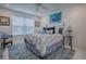 Bright bedroom with a comfortable bed, stylish decor, and ample natural light at 17009 Se 96Th Chapelwood Cir, The Villages, FL 32162