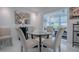 Elegant dining area with a glass table, seating for four, and neutral decor at 17009 Se 96Th Chapelwood Cir, The Villages, FL 32162