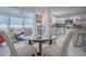 Dining area near an open concept kitchen and screened-in porch with bright, natural light at 17009 Se 96Th Chapelwood Cir, The Villages, FL 32162