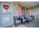 Welcoming front porch featuring comfortable seating and charming decorative accents at 17009 Se 96Th Chapelwood Cir, The Villages, FL 32162