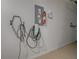 Garage wall features EV charger, electrical panel, fire extinguisher, and tool rack at 17009 Se 96Th Chapelwood Cir, The Villages, FL 32162