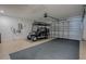 Spacious garage with golf cart parking, automatic door, and durable epoxy flooring at 17009 Se 96Th Chapelwood Cir, The Villages, FL 32162