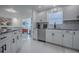 Bright kitchen with sleek white cabinets, stainless steel appliances, and modern finishes at 17009 Se 96Th Chapelwood Cir, The Villages, FL 32162