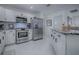 Well-equipped kitchen featuring stainless steel appliances and ample counter space at 17009 Se 96Th Chapelwood Cir, The Villages, FL 32162