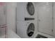 Modern laundry area with stacked washer and dryer, offering convenience and space-saving design at 17009 Se 96Th Chapelwood Cir, The Villages, FL 32162