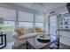 Cozy living room featuring a plush sofa, natural light, and stylish decor at 17009 Se 96Th Chapelwood Cir, The Villages, FL 32162