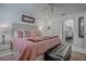 Elegant bedroom featuring a comfortable bed, modern decor, and access to the bathroom at 17009 Se 96Th Chapelwood Cir, The Villages, FL 32162