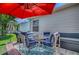 Outdoor patio with seating, umbrella, and grill, perfect for backyard entertaining at 17009 Se 96Th Chapelwood Cir, The Villages, FL 32162