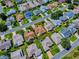 An aerial view showcases the home and neighborhood within a red boundary line at 1701 Lakewood Dr, The Villages, FL 32162