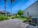 Well-maintained backyard featuring a paved patio, lush landscaping, and mature trees for privacy at 1701 Lakewood Dr, The Villages, FL 32162