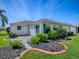 Charming home featuring well-manicured landscaping, lush lawn, and a private patio for outdoor enjoyment at 1701 Lakewood Dr, The Villages, FL 32162