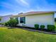 The house has light yellow siding, green shutters, and is surrounded by a well-maintained lawn at 1701 Lakewood Dr, The Villages, FL 32162