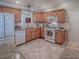 Well-equipped kitchen with modern appliances, ample counter space, and tile flooring that blends functionality with style at 1701 Lakewood Dr, The Villages, FL 32162