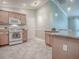 Well-lit kitchen offers modern appliances, tile flooring, and ample storage, perfect for cooking and entertaining guests at 1701 Lakewood Dr, The Villages, FL 32162