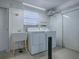 Practical laundry room featuring a utility sink, washer, and dryer for convenient household chores at 1701 Lakewood Dr, The Villages, FL 32162