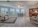 Brightly lit living area with tile floors, modern lighting and comfortable seating at 1701 Lakewood Dr, The Villages, FL 32162