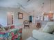 Bright and airy living room featuring tile flooring, a ceiling fan, and comfortable seating, open to other living spaces at 1701 Lakewood Dr, The Villages, FL 32162