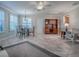 Bright living room with tile floors, plantation shutters, and access to dining and living areas for easy flow at 1701 Lakewood Dr, The Villages, FL 32162
