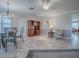 Open-concept living space featuring tile flooring, neutral walls, and a breakfast bar pass-through to the kitchen at 1701 Lakewood Dr, The Villages, FL 32162