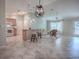 Open living space with kitchen island, tile flooring, modern lighting, and comfortable seating area at 1701 Lakewood Dr, The Villages, FL 32162