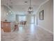 Inviting living area with tile floors, open layout, modern light fixtures, and seamless flow to the kitchen at 1701 Lakewood Dr, The Villages, FL 32162