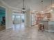 Beautiful open concept space with tile flooring and a seamless flow from the kitchen to the dining room and living space at 1701 Lakewood Dr, The Villages, FL 32162