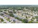 Expansive aerial view showcasing the neighborhood's well-maintained homes and verdant tree coverage at 17068 Se 96Th Chapelwood Cir, The Villages, FL 32162