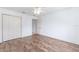Bedroom features a ceiling fan, closet, hardwood flooring and neutral wall color at 17068 Se 96Th Chapelwood Cir, The Villages, FL 32162