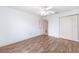 Bedroom features hardwood flooring, a ceiling fan, closet and neutral paint at 17068 Se 96Th Chapelwood Cir, The Villages, FL 32162