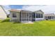 Rear exterior showcasing a screened lanai, perfect for enjoying the outdoors in a private, comfortable setting at 17068 Se 96Th Chapelwood Cir, The Villages, FL 32162