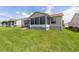 Rear exterior featuring a screened porch, enhancing outdoor enjoyment in this inviting residential space at 17068 Se 96Th Chapelwood Cir, The Villages, FL 32162