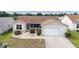 Charming single-story home with a well-manicured lawn, attached garage, and welcoming front entrance at 17068 Se 96Th Chapelwood Cir, The Villages, FL 32162